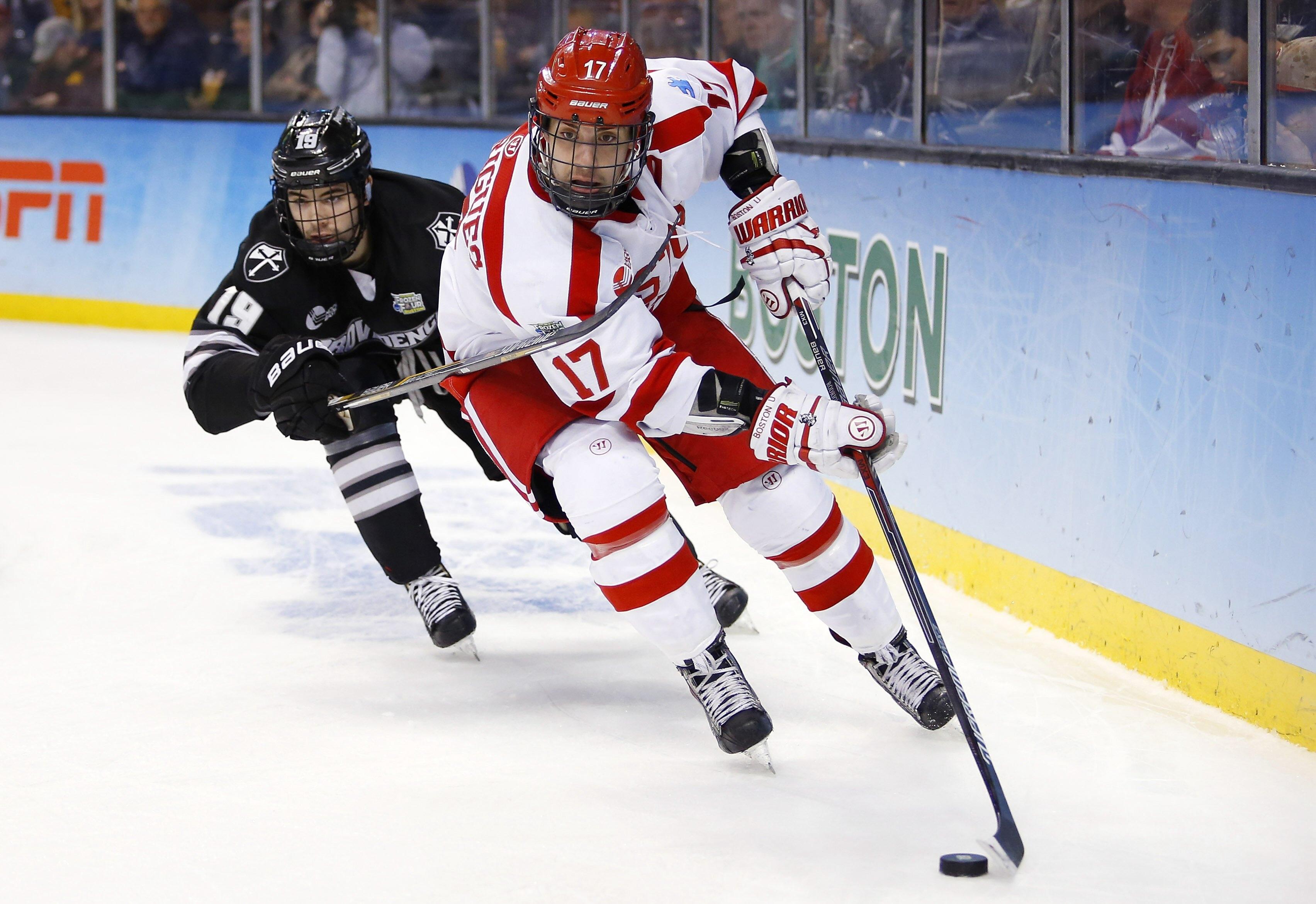 Evan Rodrigues goes around Providence College Friars defenseman Jake Walman