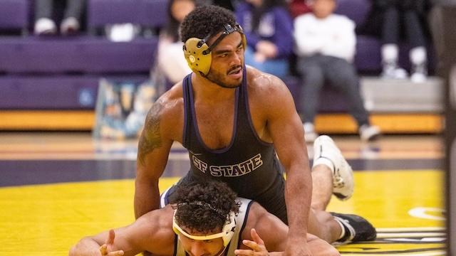Kweli Hernandez pins an opponent in DII wrestling. 