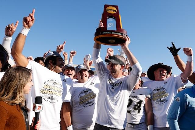 Head coach Paul Simmons lifts Harding's DII football trophy.