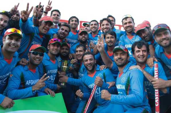 Afghanistan's players pose with the series trophy after they won the fifth and final ODI.