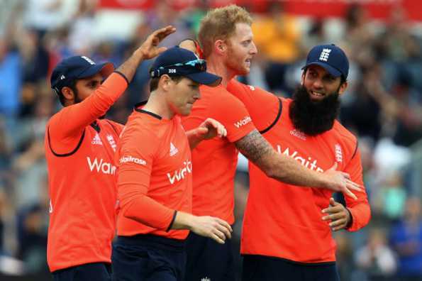 England's Adil Rashid (L), Eoin Morgan (2nd L) and Moeen Ali (R) congratulate Ben Stokes (2nd R) during his three-wicket, last over during a Twenty20 International against Australia at The Swalec Stadium in Cardiff, south Wales, on August 31, 2015