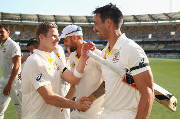 Australian captain Steve Smith and team mate Mitchell Johnson of Australia embrace after winning the match during day four of the 2nd Test match