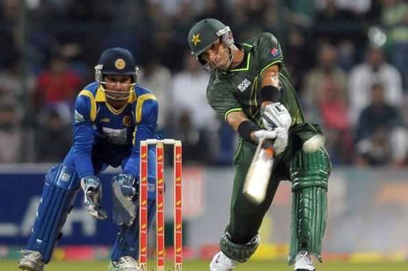 Pakistan's cricket captain Misbah-ul-Haq (R) plays a shot as Pakistan's wicketkeeper Kumar Sangakkara look on during the Twenty20 match between Pakistan and Sri Lanka at the Sheikh Zayed Cricket Stadium in Abu Dhabi. Pakistan beat Sri Lanka by five wickets in a thrilling finish to the only Twenty20 international played at Abu Dhabi stadium here on Friday.