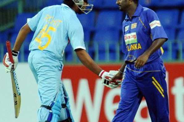 Sri Lanka's Muttiah Muralitharan (R) is congratulated by India's Rohit Sharma (L) for breaking the one-day record for most number of wickets. Muralitharan completed a record bowling double when he dismissed Indian batsman Gautam Gambhir in his 10th and last over in the fourth match in Colombo on Thursday, surpassing former Pakistan paceman Wasim Akram's one-day mark of 502.