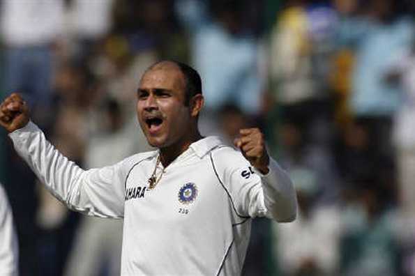 India's Virender Sehwag celebrates after dismissing Australia's Cameron White on the fourth day of their third test cricket match in New Delhi in this November 1, 2008 file photo. REUTERS/Stringer