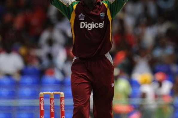 West Indies bowler Fidel Edwards reacts to missplayed hit from Australian cricketer Luke Ronchi at Warner Park in Basseterre, St Kitts. Australis won by one run