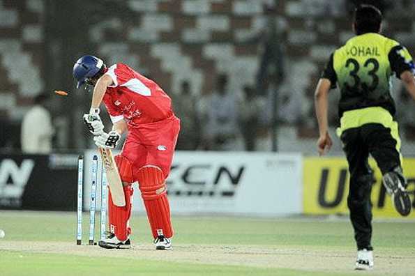 Hong Kong cricketer Courtney Kruger(L) is bowled out by Pakistani bowler Sohail Tanveer(R) during their Asian Cup Group B match in Karachi. Tanveer shone with both bat and ball to steer Pakistan to a 155-run win over Hong Kong.